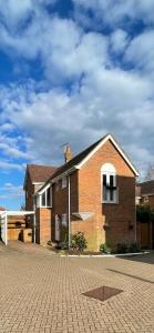 a brick building with a balcony on a brick road at St Dunstan's Hideaway in Canterbury