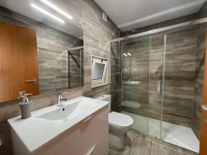 a bathroom with a toilet and a sink and a shower at Casa Botica - Gerês Country House in Terras de Bouro +20 photos