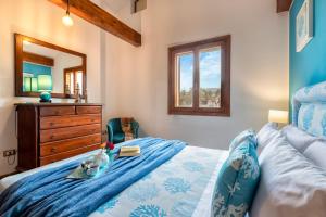 a bedroom with a bed with a dresser and a mirror at Brassol Casa Vacanze Vista Mare in Alghero