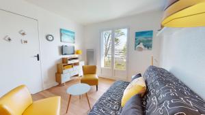 a living room with a couch and a table at Le Ponton Bleu vue face au Port in Saint-Gilles-Croix-de-Vie