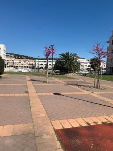 an empty street with trees and buildings in the background at App T2 climatisé , plage 200 m in Sète +13 photos
