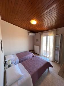 A bed or beds in a room at Anatolí Village House