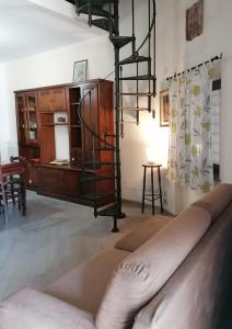a living room with a loft bed and a table at Casa del Palazzo del Marchese in Tarquinia