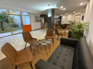 an office lobby with chairs and a couch and tables at AR Bolero park in Lloret de Mar