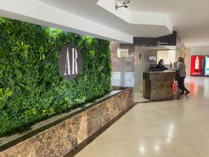 a lobby with a green wall in a building at AR Bolero park in Lloret de Mar