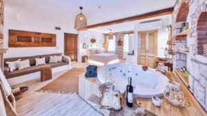 a large bathroom with a large tub in a room at Cumbali Konak Hotel (Adults Only +12) in Alacati