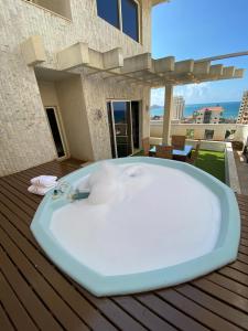 a bath tub sitting on top of a deck at Dolls Hotel By Eurostars in Jounieh