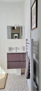 a bathroom with a sink and a mirror at Weir Cottage in Balledent