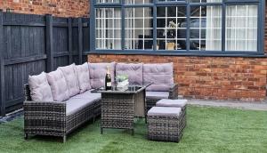 a patio with a couch and a table and chairs at Racecourse Retreat in York