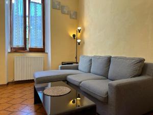 a living room with a couch and a table at Dimitri's House! view of the Cathedral in Castelnuovo di Garfagnana