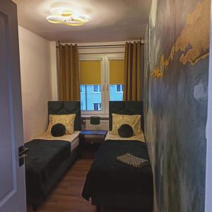 1 dormitorio con 2 camas y pared en BaltikApart, en Hel