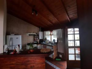 a kitchen with a counter top and a refrigerator at Horizonte Fueguino II in Ushuaia