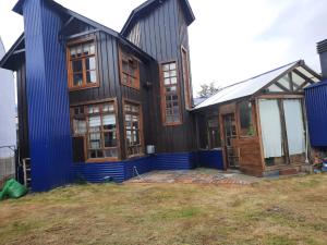 a house under construction with the front door open at Horizonte Fueguino II in Ushuaia