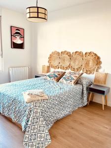 1 dormitorio con 1 cama con cabecero de madera en Apartamento a estrenar en Ribamontán al Mar, en Hoznayo