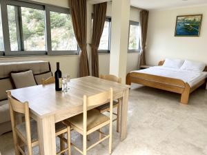 a living room with a table and a bed at Villa Blanca in Petrovac na Moru