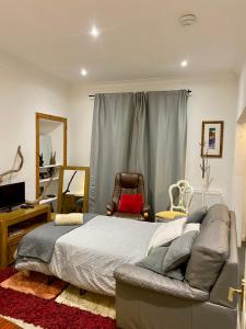 a bedroom with a bed and a desk and a chair at 4B Millhill Street in Dunfermline