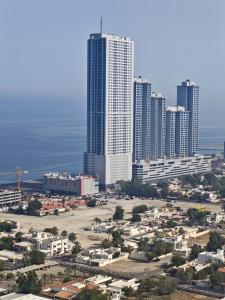 een luchtzicht op een stad met hoge gebouwen bij Pretty Room in Shared Apartment in Ajman 