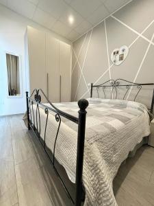a bedroom with a black bed in a room at Cielo Stellato in Polignano a Mare