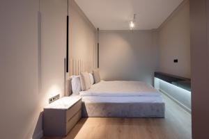 a small bedroom with a bed and a desk at Opera Apartments in Cluj-Napoca