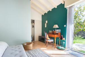 a bedroom with a desk and a bed and a desk at La Chambre Verte in Cazères