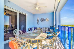 a patio with a table and chairs on a balcony at Oceanwalk 17-406 in New Smyrna Beach