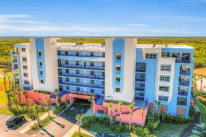 an overhead view of a building with palm trees at Oceanwalk 17-406 in New Smyrna Beach