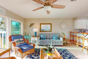 a living room with a couch and a ceiling fan at Whitney Beach 149 in Longboat Key