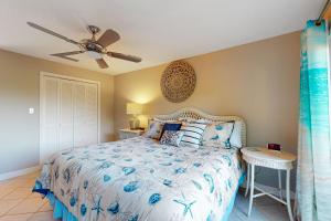 a bedroom with a bed and a ceiling fan at Whitney Beach 149 in Longboat Key