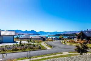 a winding road through a small town with a lake at Castle Hall - Lake Tekapo in Lake Tekapo