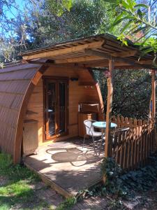 a small wooden cabin with a table in front of it at Igloo Mobil Home in Soiano del Lago