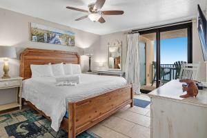 a bedroom with a bed and a balcony at Wind Drift 408SW in Perdido Key