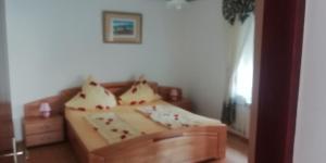 a bedroom with a bed with pillows on it at Apartmani kod Rade in Pakoštane