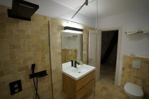 a bathroom with a sink and a glass shower at NICA Chalet in Fundata