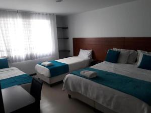 Postel nebo postele na pokoji v ubytování Hotel Casa Lamay