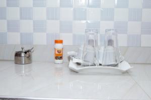 a kitchen counter with two glass blenders on a counter at WestWay Luxury Suites in Mbarara