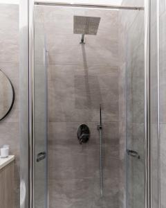 a shower with a glass door with a basketball hoop at Nena Sweet Home in Palermo