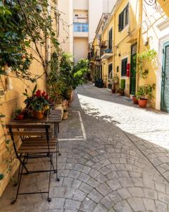 an empty street with a table with potted plants on it at Nena Sweet Home in Palermo