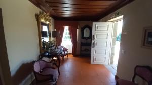a hallway with a table and chairs and a door at Casa do Lobo in Lamego
