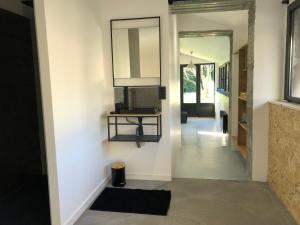 a hallway of a house with a mirror on the wall at L’atelier in Grane