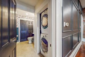 a hallway with a washer and dryer in a house at Luxury 8 Bed/4 Ba NuLu Home Private yard/parking in Louisville
