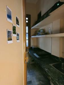 a kitchen with a sink and pictures on the wall at Namaste Amritsar Homestay in Amritsar +9 photos