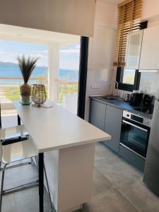a kitchen with a table and a view of the ocean at Casa al Mare in Nea Roda