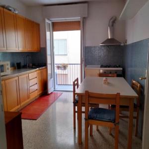 a kitchen with a table and chairs and a dining room at Daniele's flat in Venice Mestre in Mestre