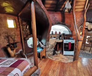 a room with a kitchen with a stove in it at La Choza - Casa Suaya La Esperanza in Ibarra