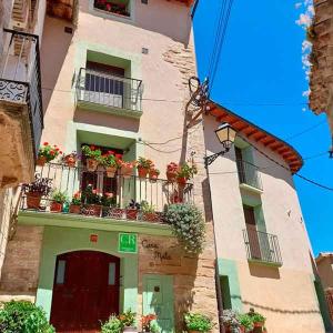 a tall building with flower boxes on the balconies at Apartamentos Casa Mata in Colungo