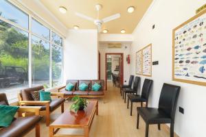 a waiting room with couches and chairs at Sevinex Inn in Feridhoo