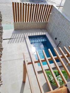 an overhead view of a swimming pool with two chairs at Casa de férias nos lençóis maranhenses in Barreirinhas