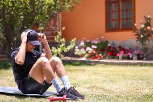 a man sitting on a surfboard in the grass at The House in Tacna