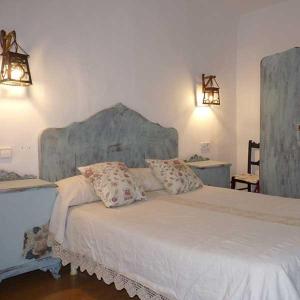 a bedroom with a large white bed with two pillows at Apartamentos Casa Mata in Colungo