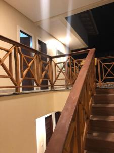 a staircase with wooden railings in a building at Casa de férias nos lençóis maranhenses in Barreirinhas